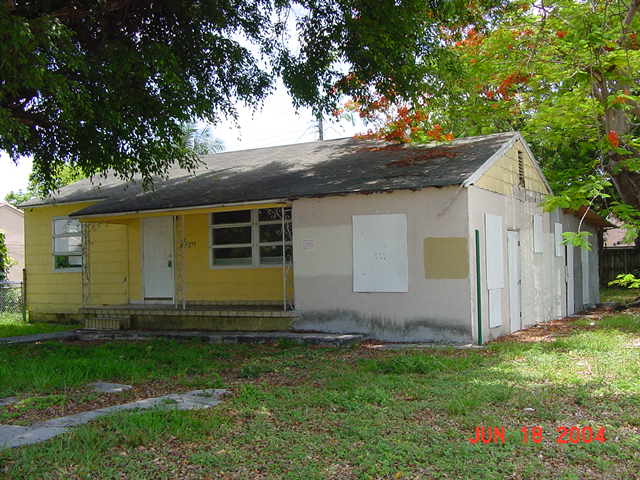 Front of home with violations before rehabilitation