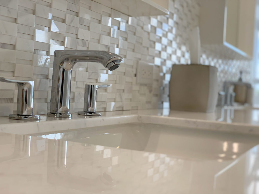 Close-up after photo of quartz countertop and stone mosaic backsplash