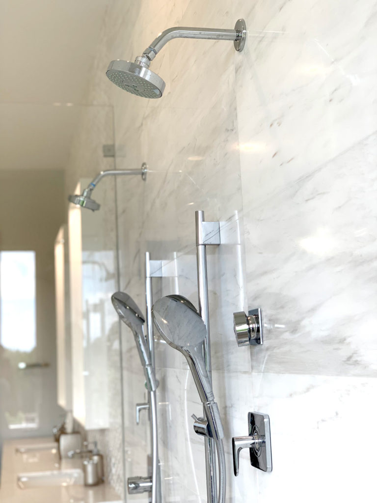 Close-up after photo of body-jets and hand-shower in shower enclosure