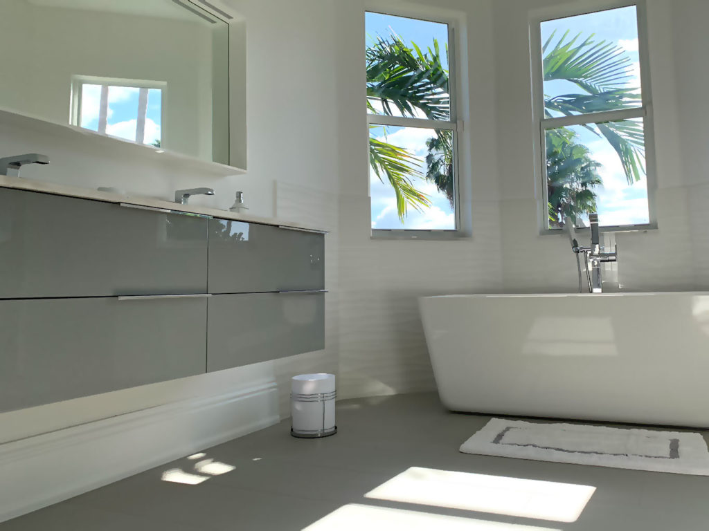 Remodeled bathroom with double vanity and freestanding tub