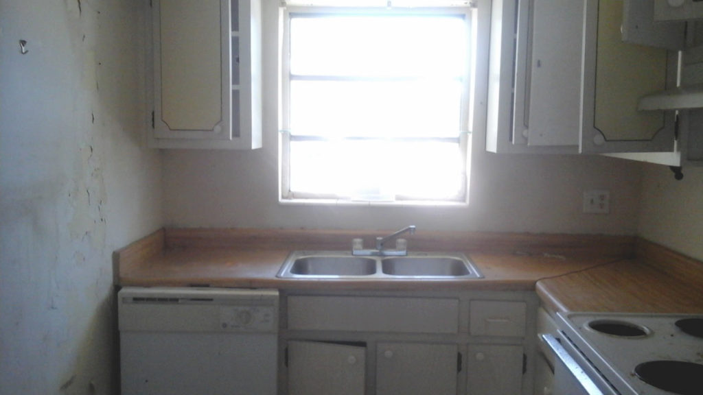 Before photo of remodeled small l-shaped kitchen