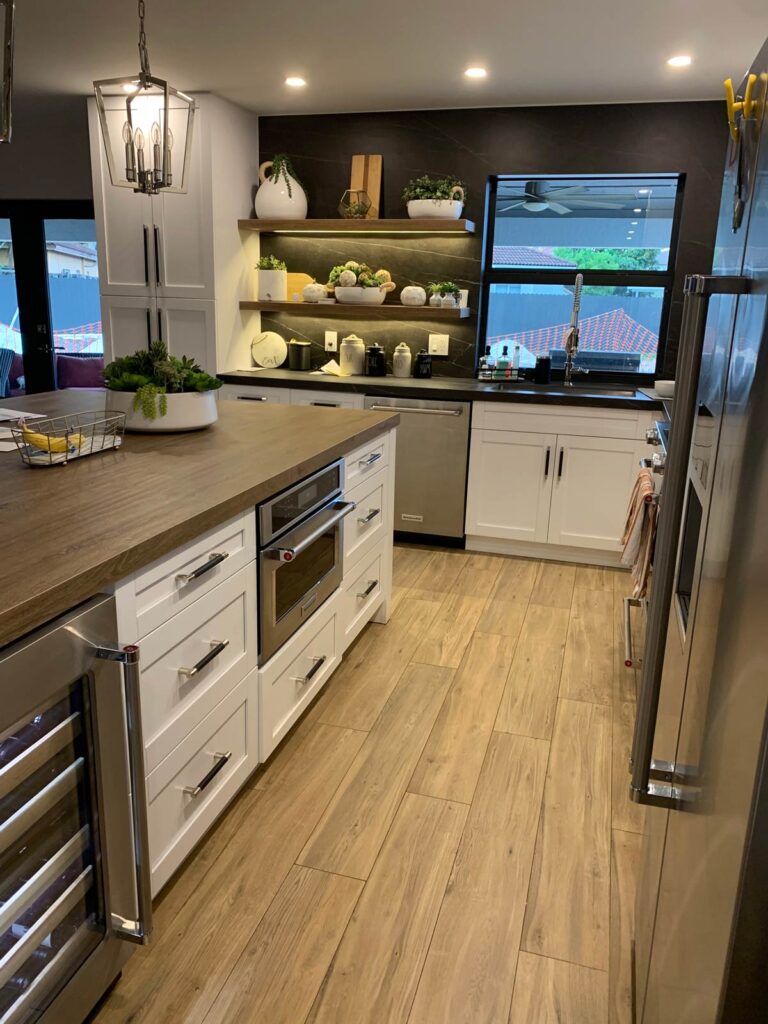 Open concept kitchen featuring white shaker cabinets and KitchenAid appliances