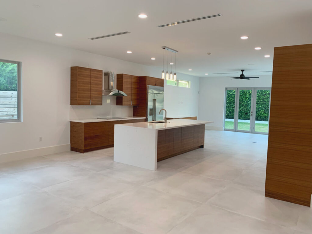 Dining area and kitchen with island and wood grain cabinets