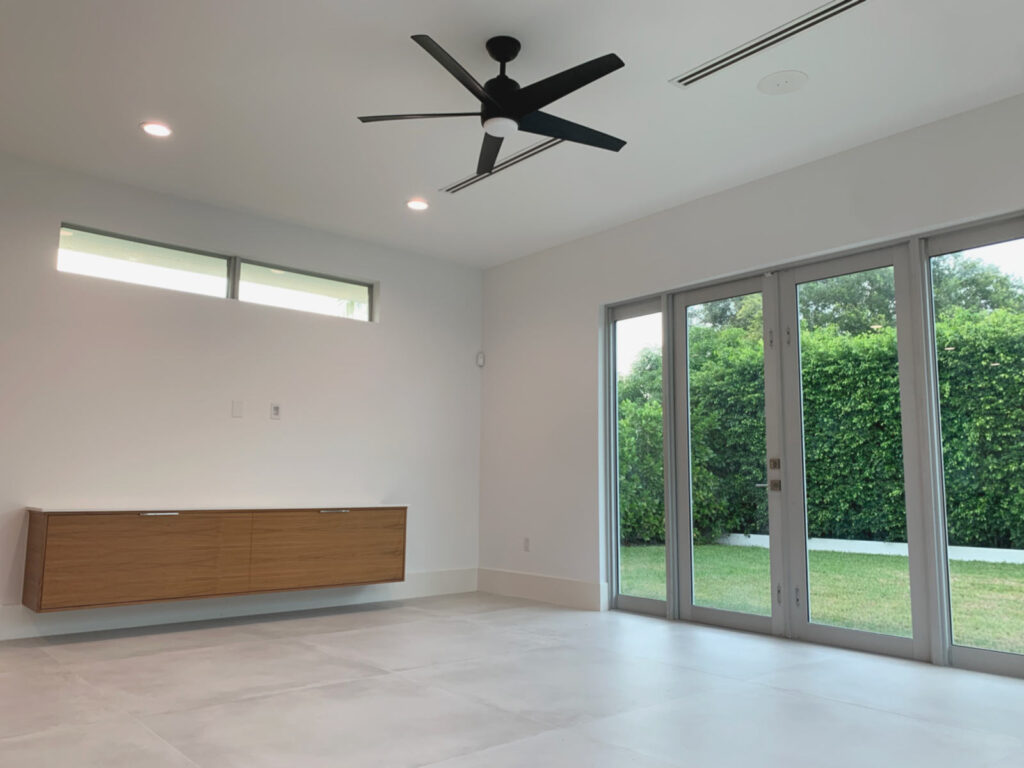 View of family room with floating entertainment console and 8 ft french doors