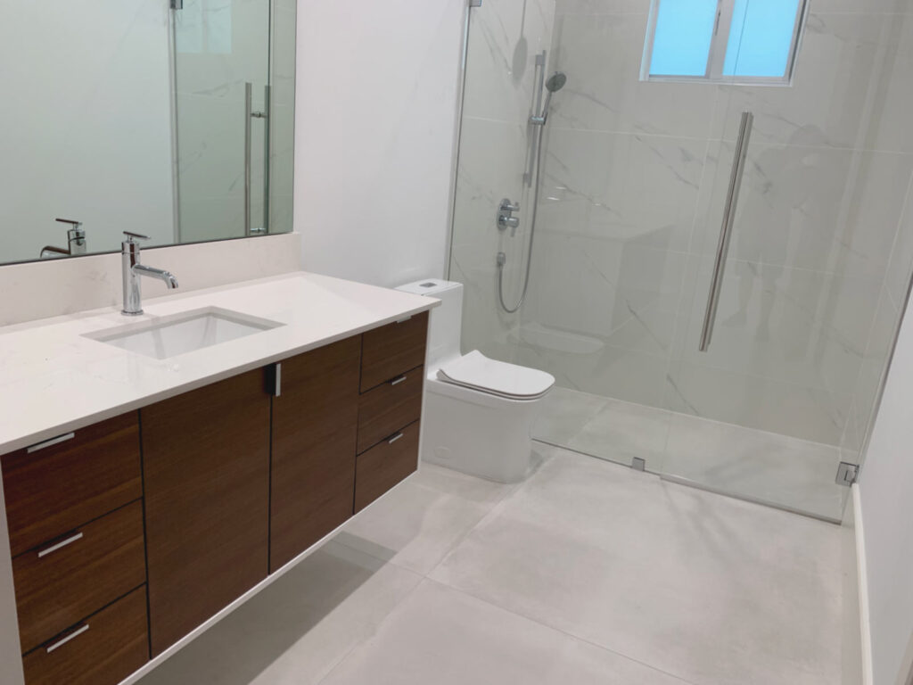 Guest bathroom with floating vanity and glass shower enclosure