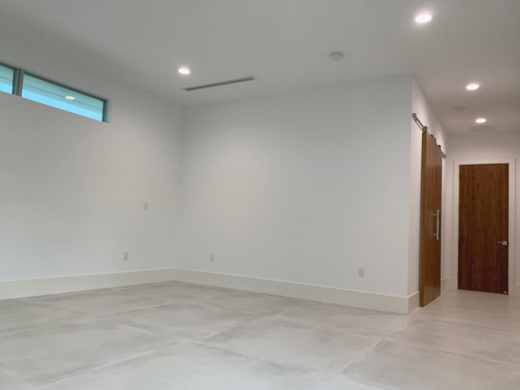 Wide view of primary bedroom, including walk-in closet with barn doors